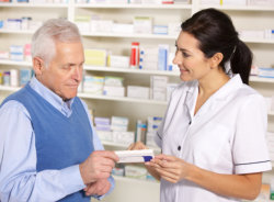 Elder man talking to female pharmacist
